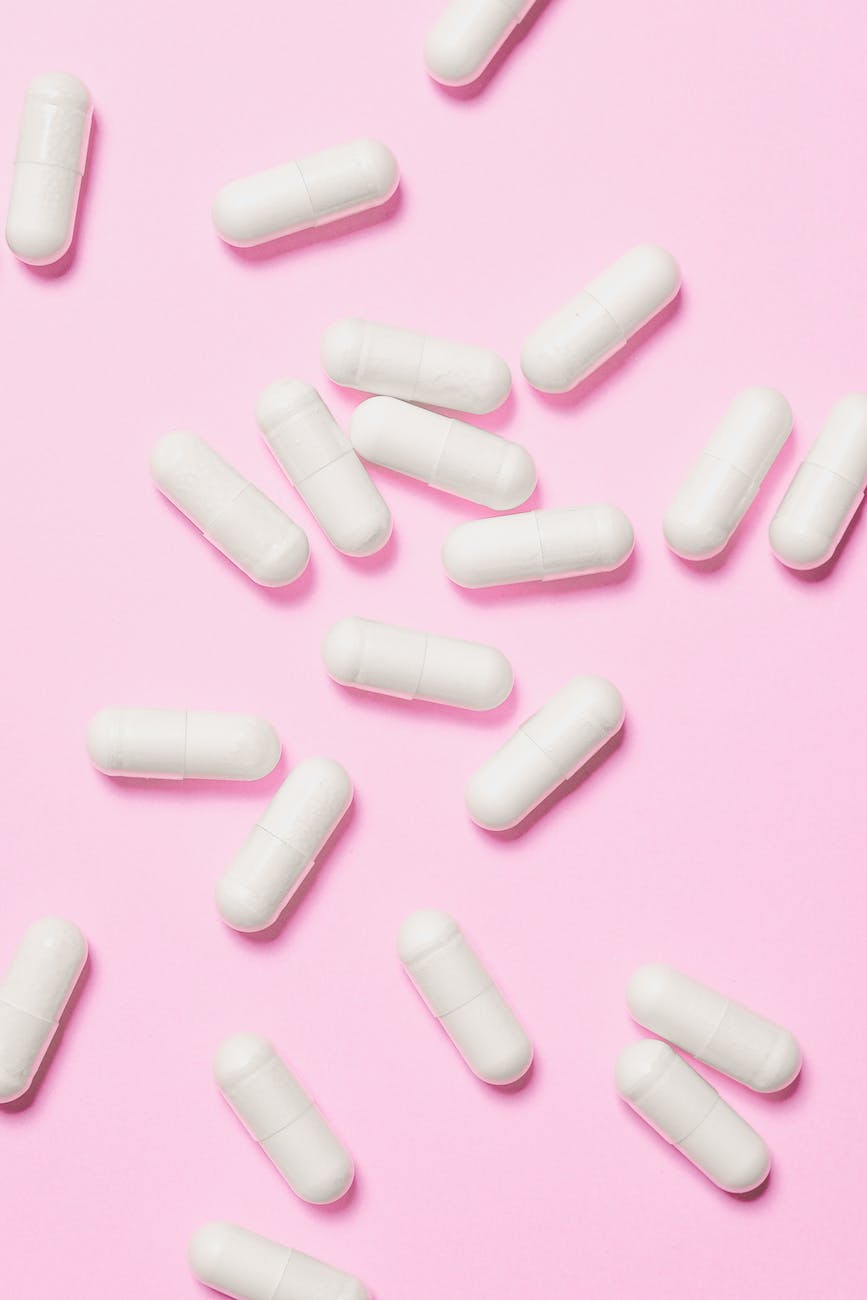 white capsules on pink surface
